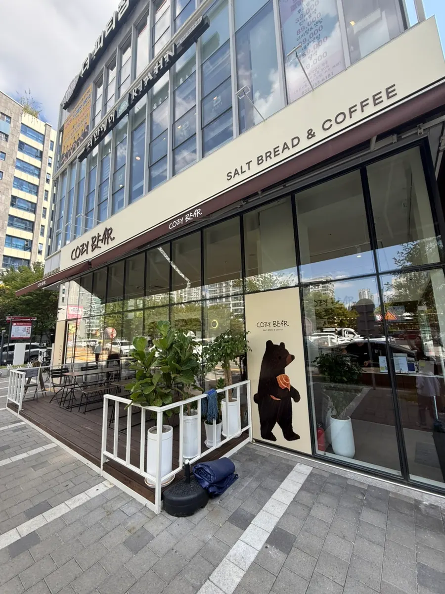 Cozy Bear's exterior and COZY BEAR sign on the first floor of Cars Plaza