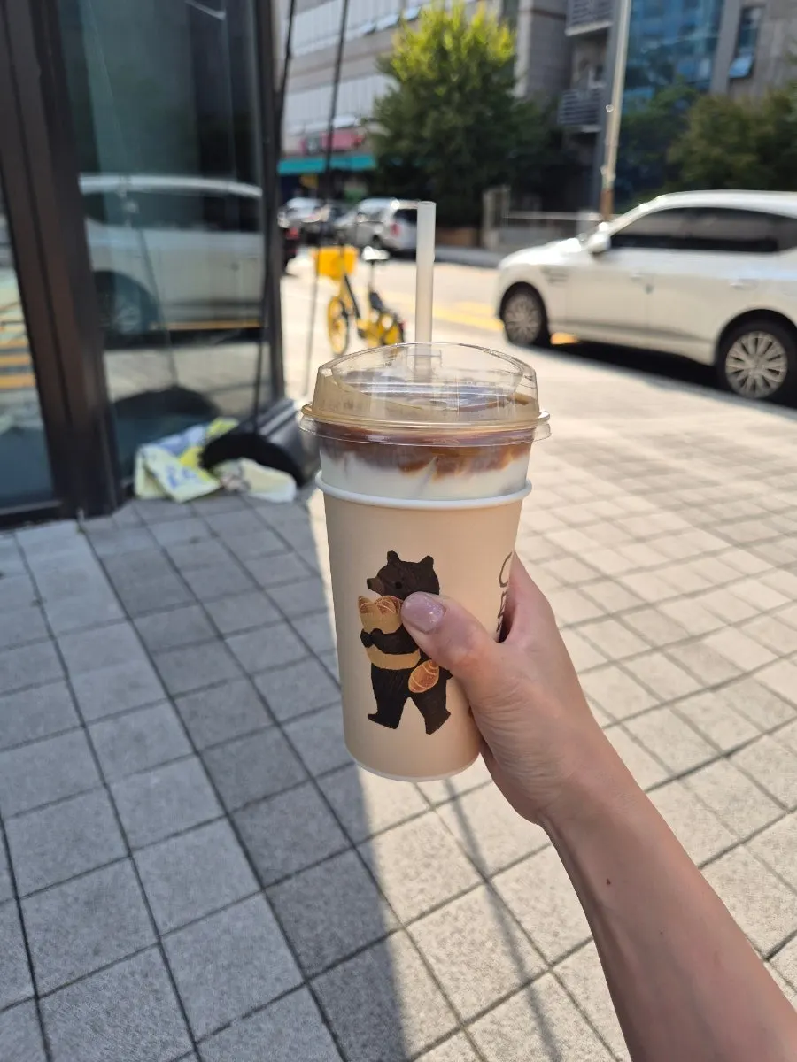 Cozy latte in a cup with the bear logo