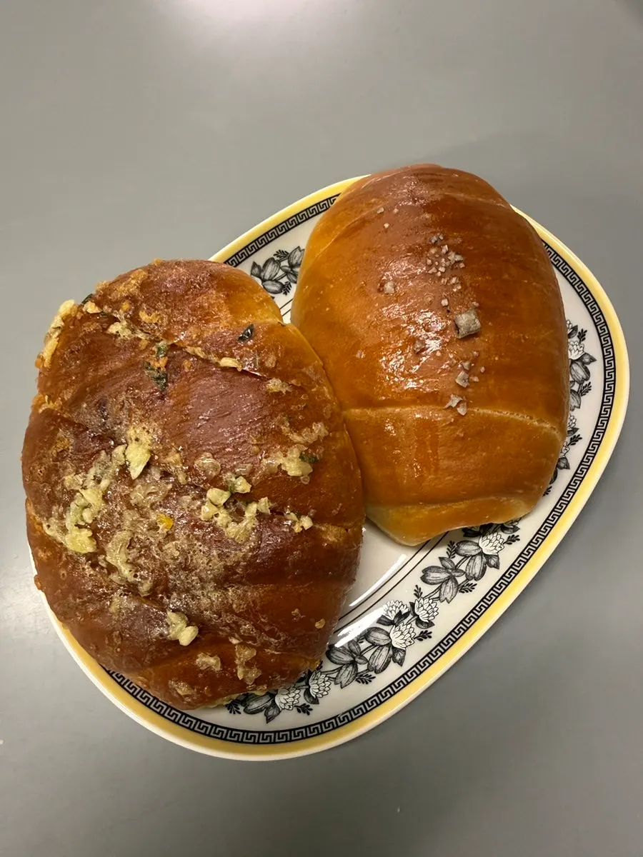 Plain and garlic salt bread laid out at home