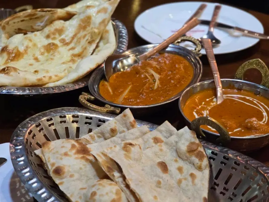 Table spread with naan and curry