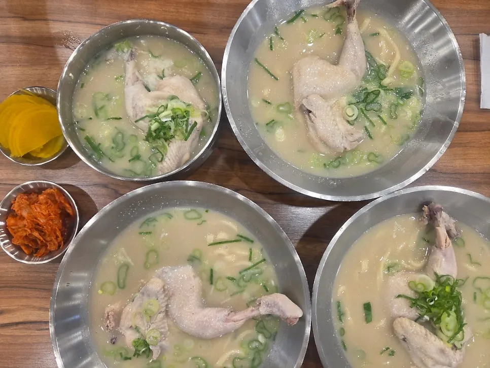 A bowl of chicken kalguksu with half a chicken