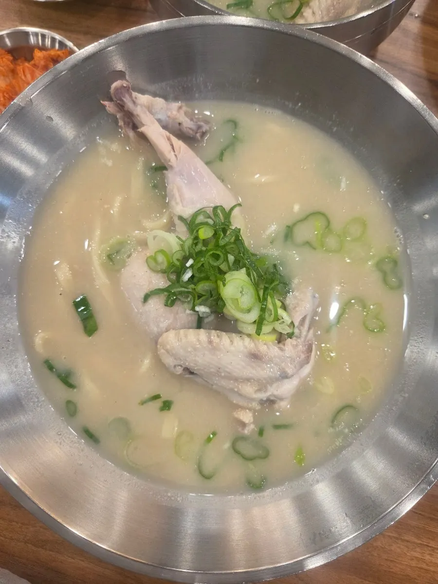 Thick, rested kalguksu noodles lifted with chopsticks