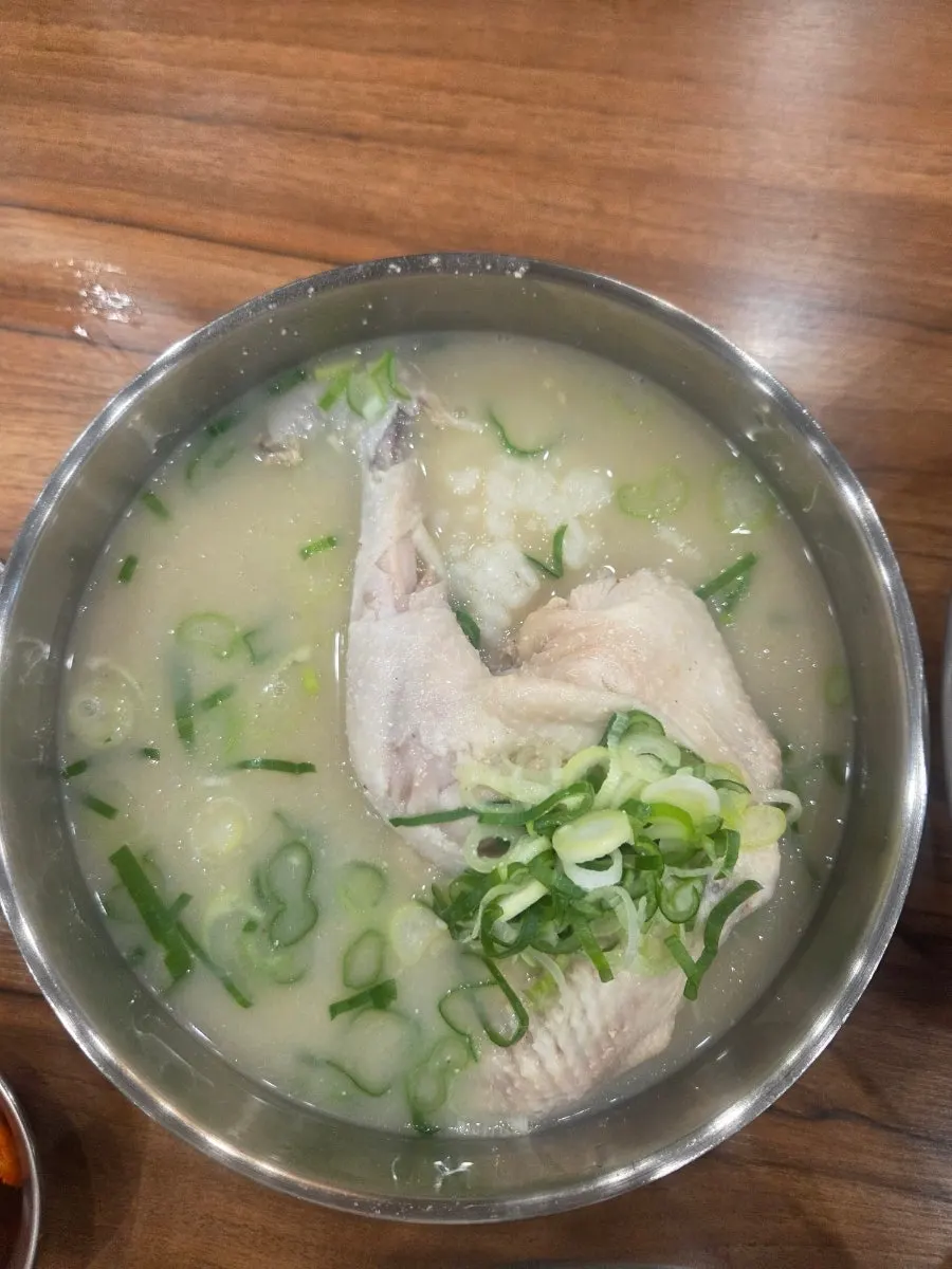 Milky dak gomtang broth served with a bowl of rice