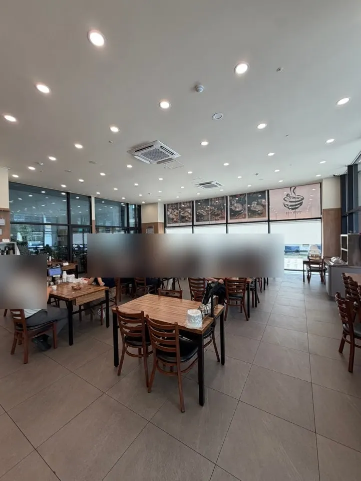 Long row of window-side solo bar seats inside the restaurant