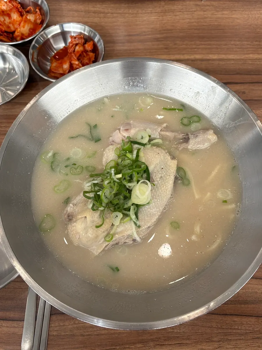 Chicken kalguksu topped with half a chicken