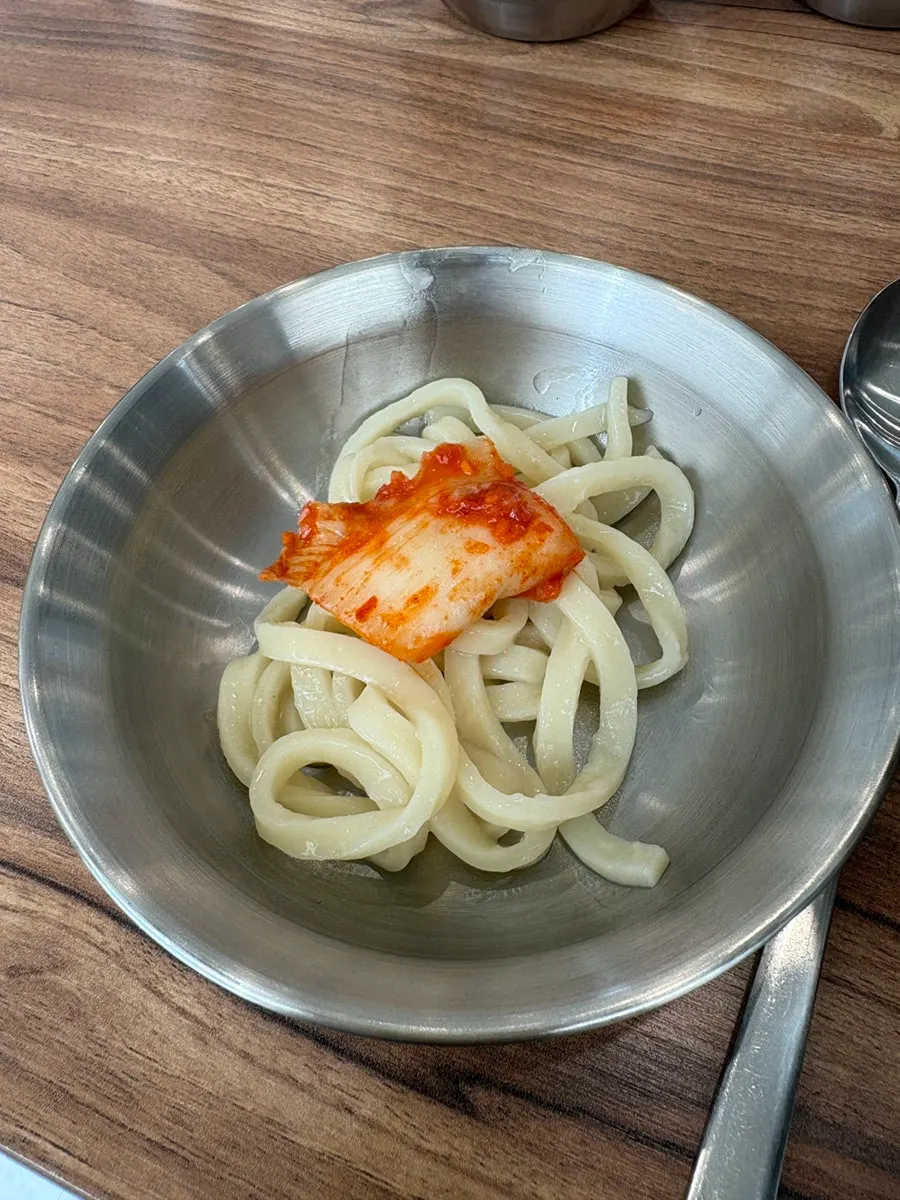 Close-up of chicken kalguksu noodles and broth