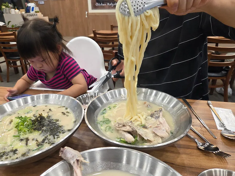 Chewy noodles lifted up from the bowl