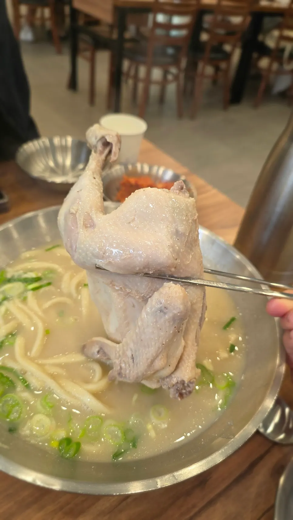 Dipping the chicken leg into peppered salt