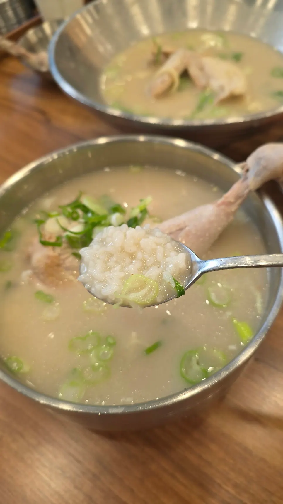 Bowl of dak gomtang with a chicken leg inside
