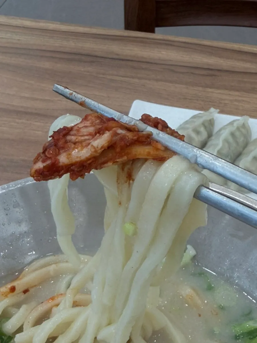 Sharply spicy kimchi placed on top of the noodles