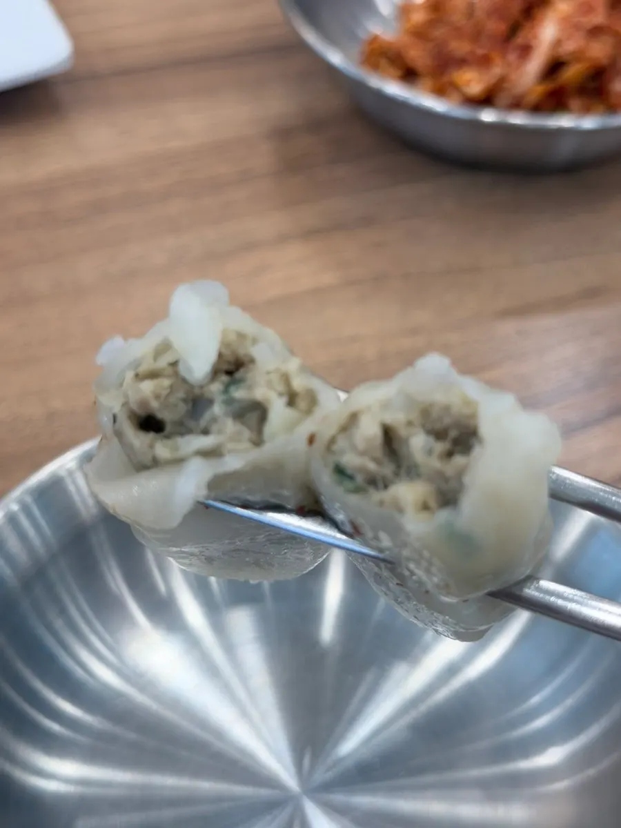 A dumpling served with soy sauce for dipping