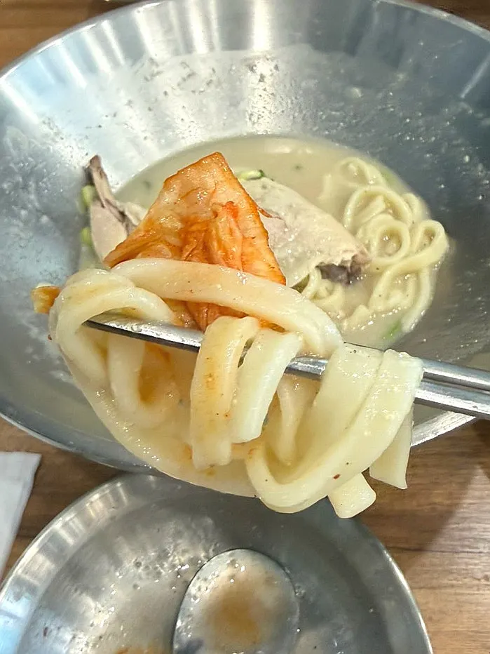 Chewy kalguksu noodles mixed into rich broth