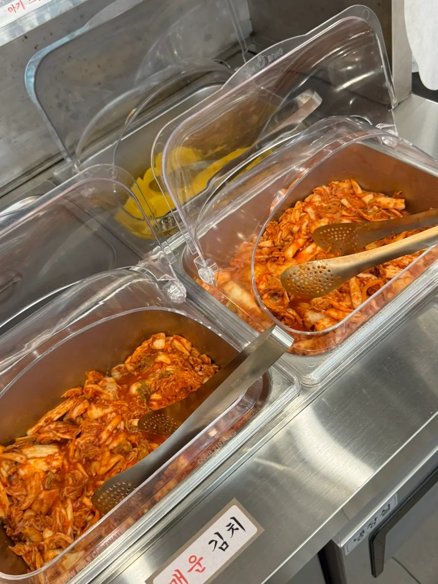 Kimchi and pickled radish set out at the self-serve bar