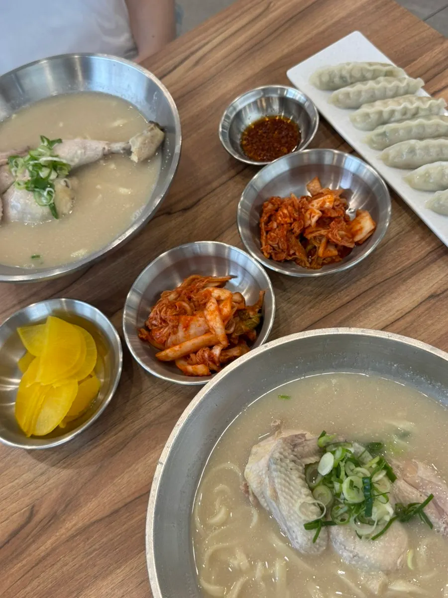 Table set with chicken kalguksu and dumplings together