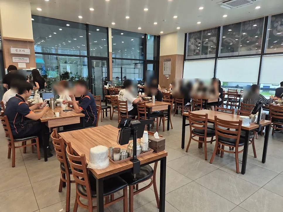 Bright interior seating lit by floor-to-ceiling windows