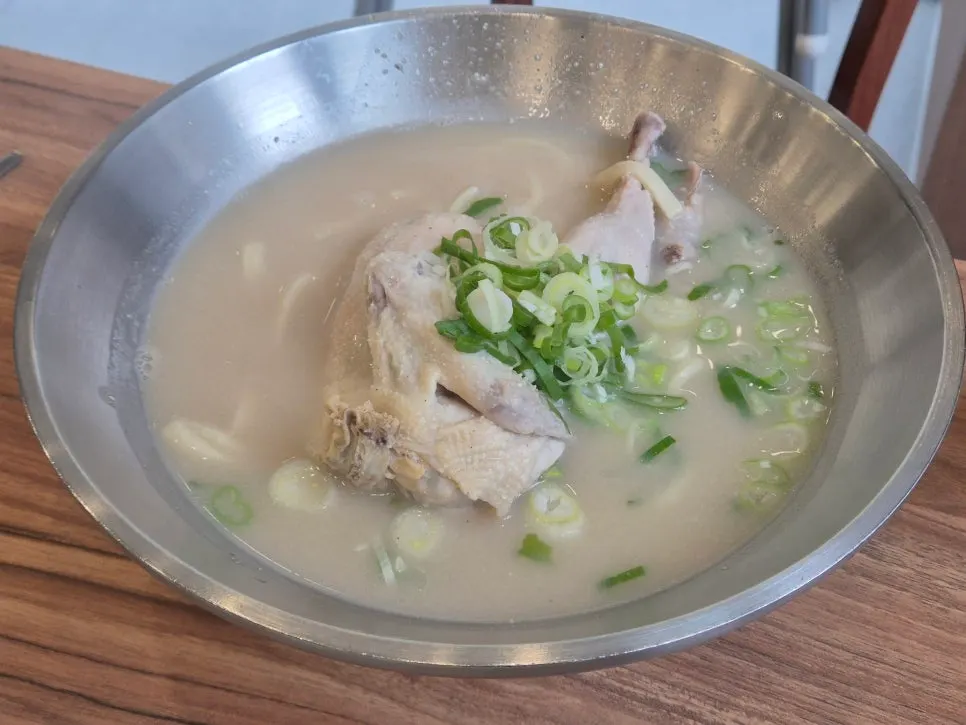 Table set with chicken kalguksu and side dishes