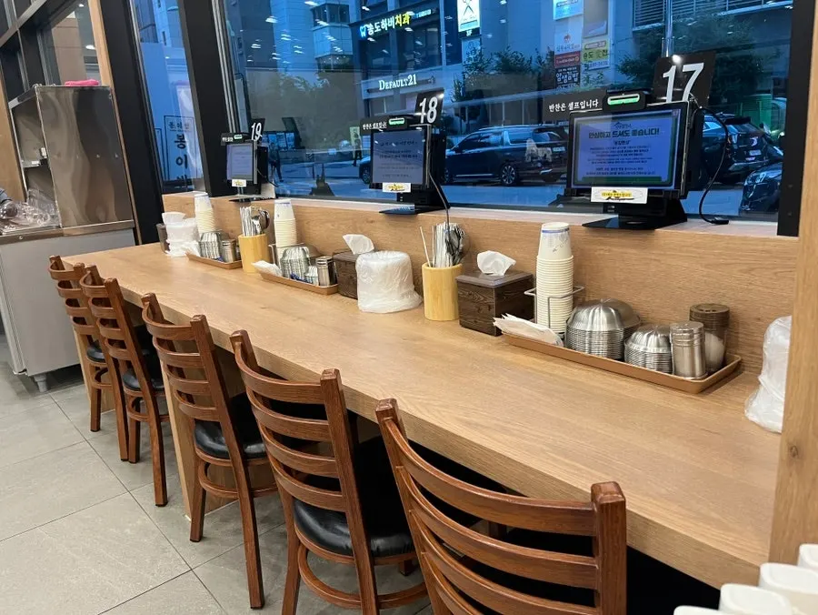Seating inside the restaurant with full-length windows
