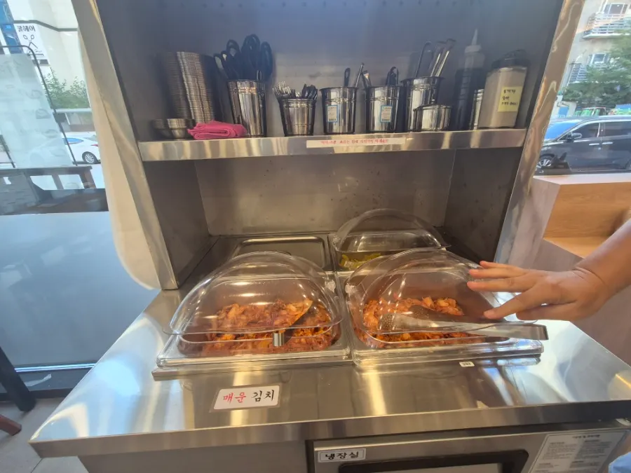 Self-serve bar with pickled radish and spicy kimchi