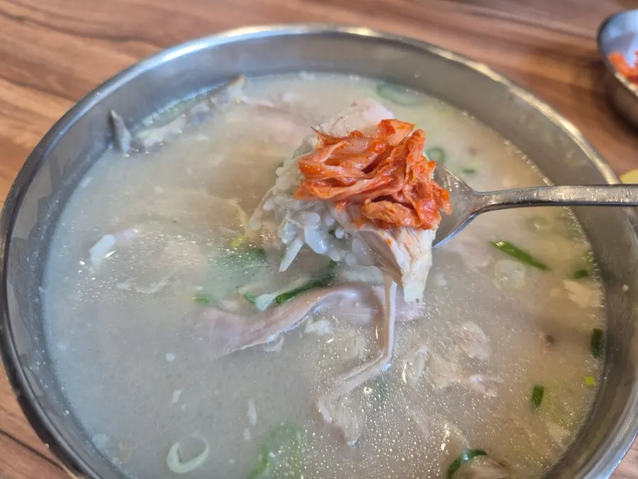 Chicken gomtang topped with kimchi