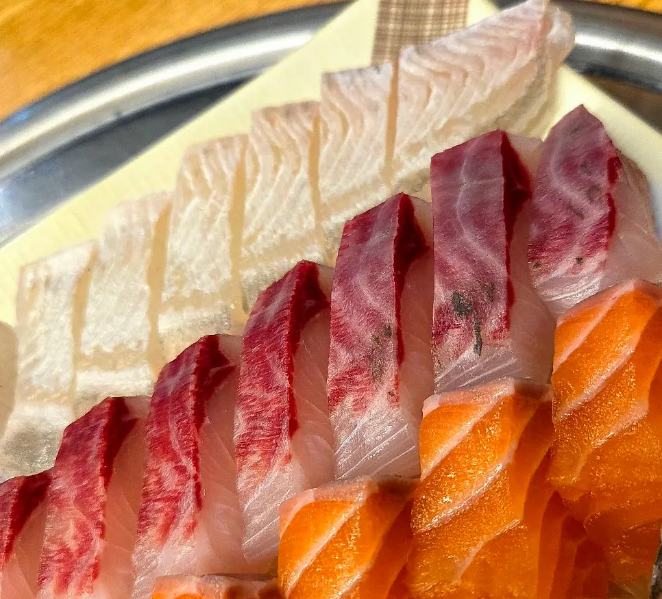 A glistening plate of live fish sashimi