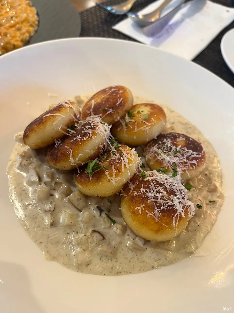 A plate of mushroom cream gnocchi