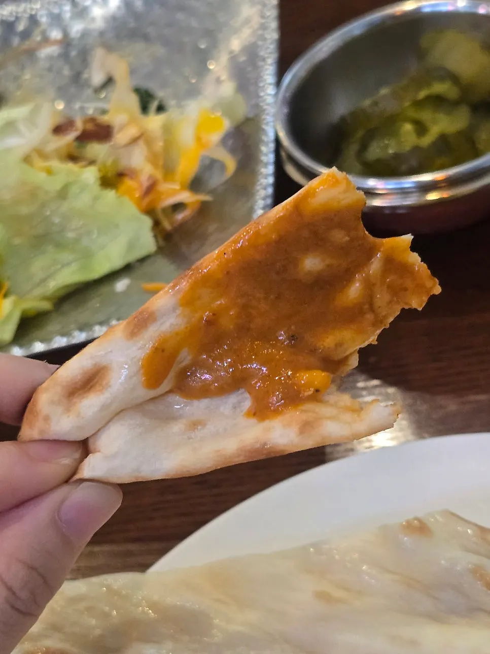 Dipping naan into the curry