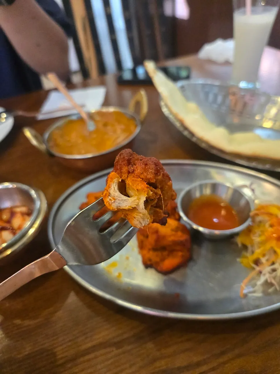 Plate with curry served alongside rice