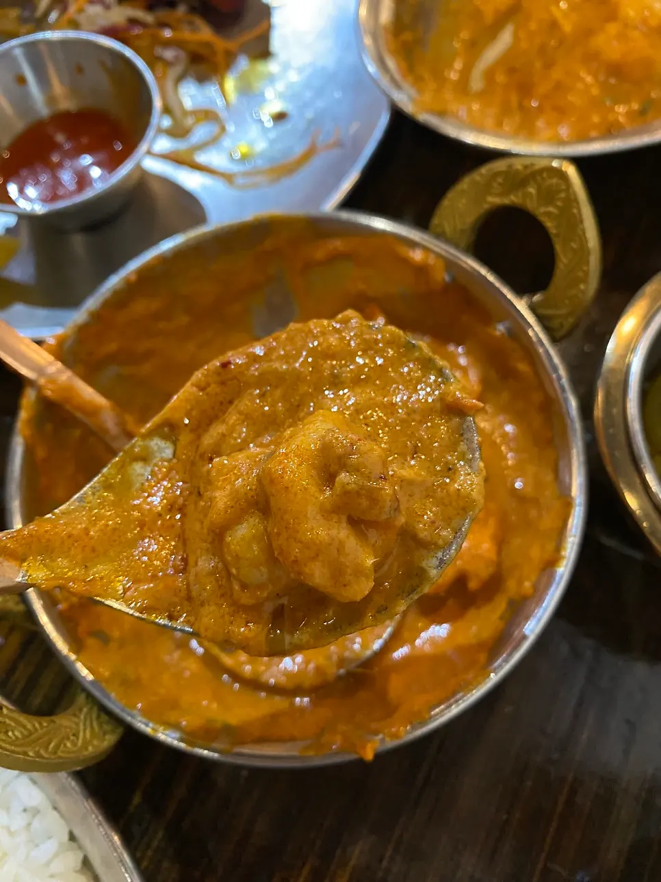 Butter chicken and prawn masala side by side