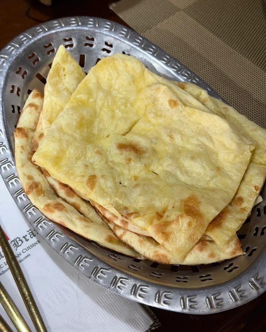 Basket of butter naan cut into several pieces