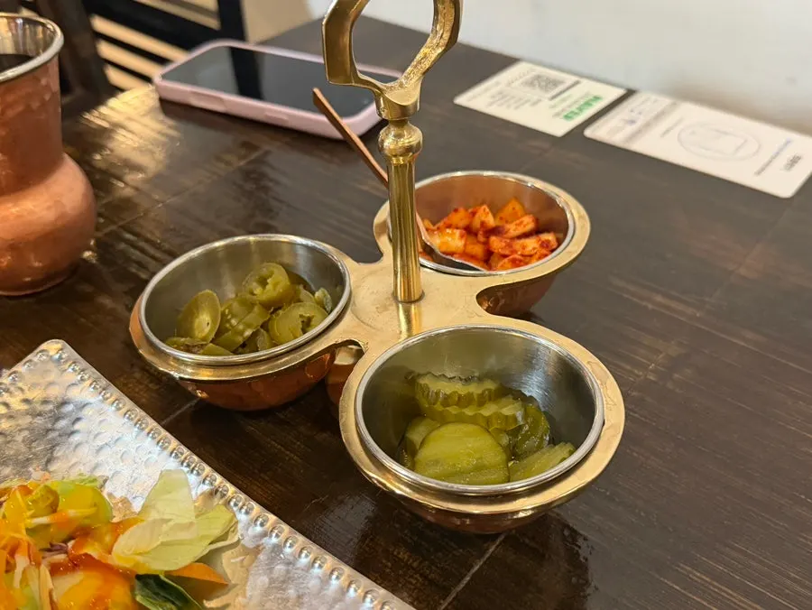 Standard side dishes: pickles, pickled chili, and marinated onion