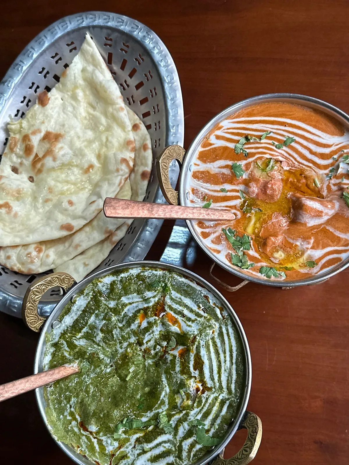 Butter chicken, palak paneer, and butter naan spread