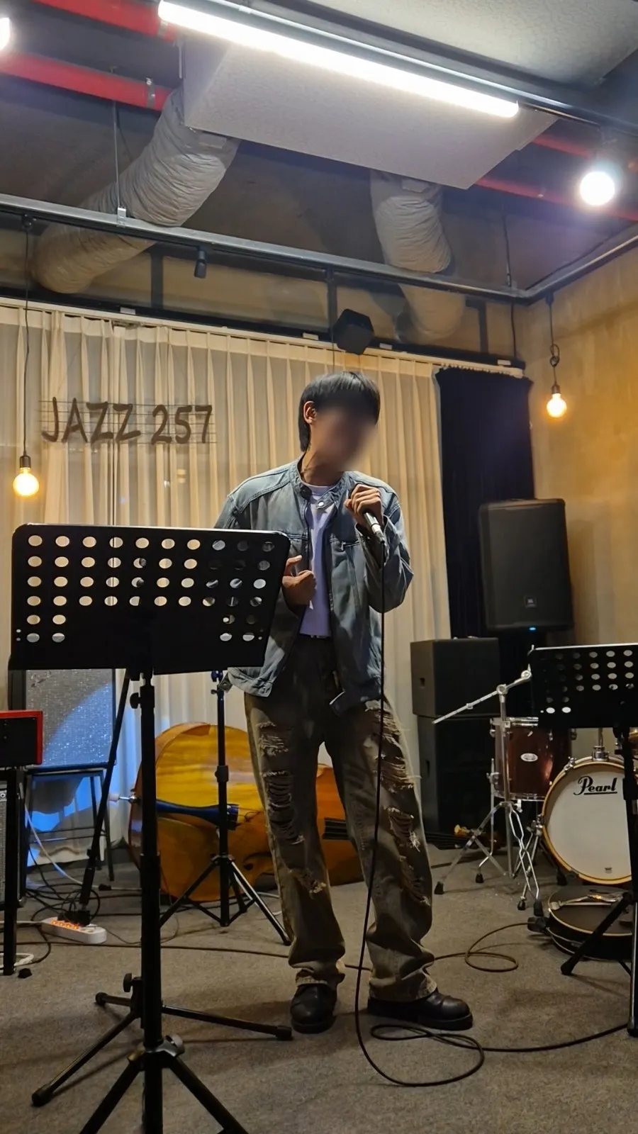 A singer on stage between Set 1 and Set 2