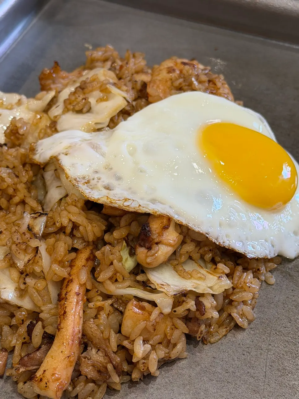 Sauced okonomiyaki on the grill