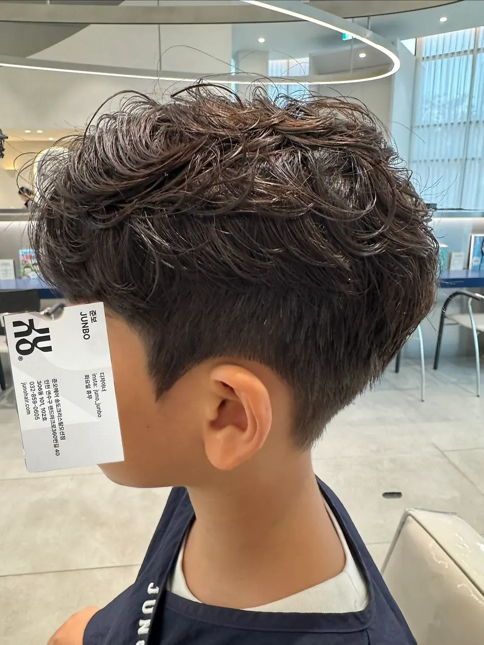 Messy, overgrown hair on a 9-year-old boy before his junior perm