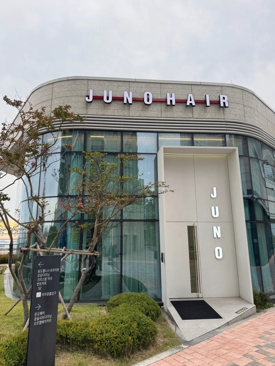 Exterior of the standalone Juno Hair building on the first floor of Crystal Ocean Square