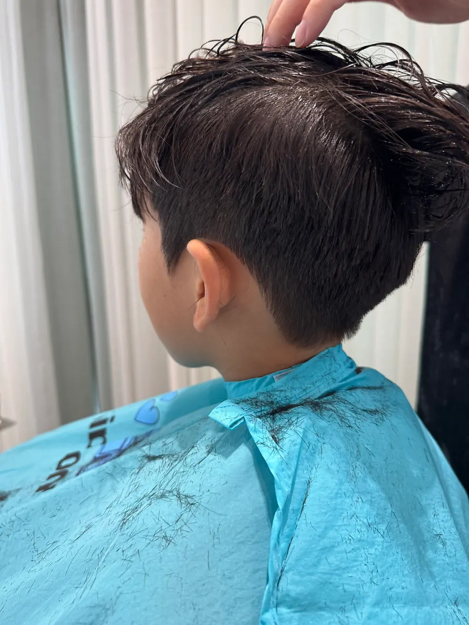 Boy's hair looking clean right after the cut