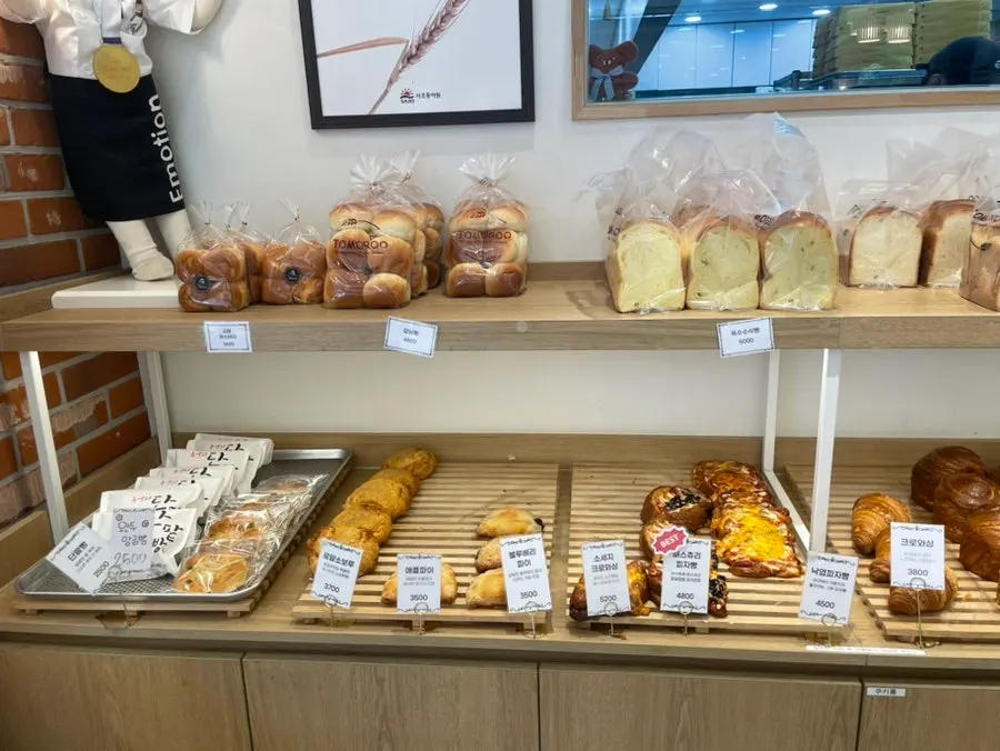 Display of sliced bread, croissants, mont blanc, and scones