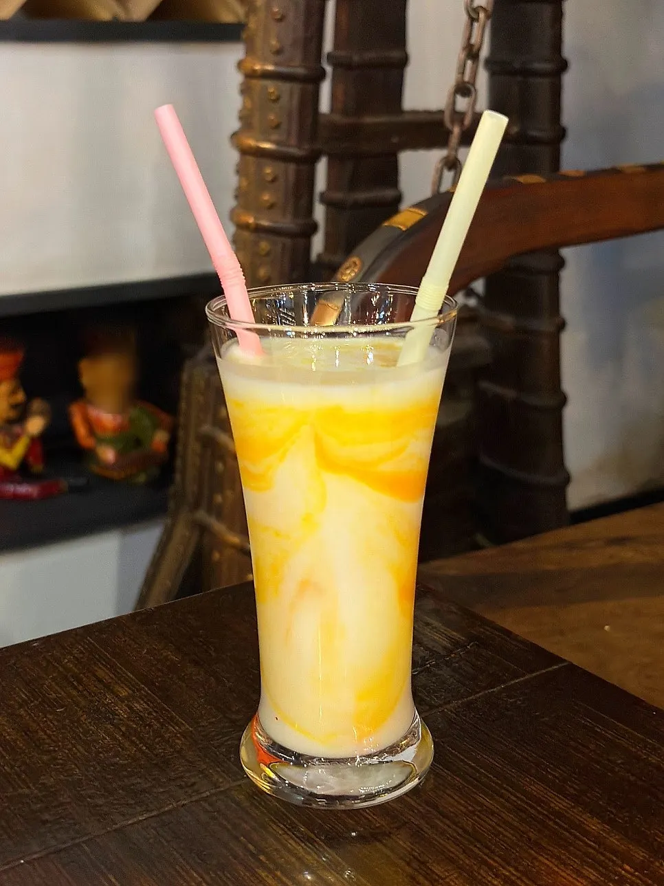 A glass of thin, watery mango lassi