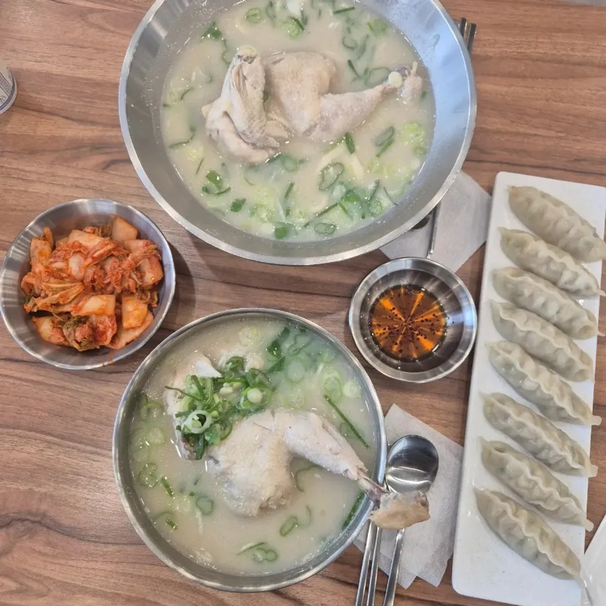 Full spread of chicken kalguksu, dak gomtang, and chewy mandu