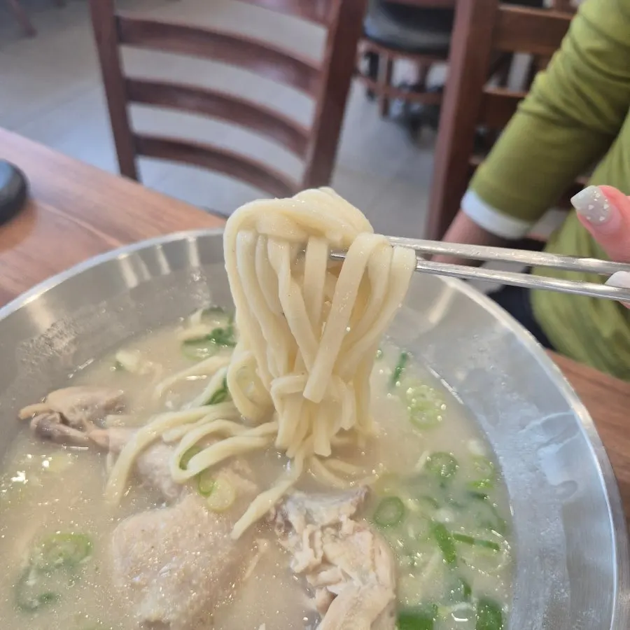 Chopsticks lifting house-made kalguksu noodles