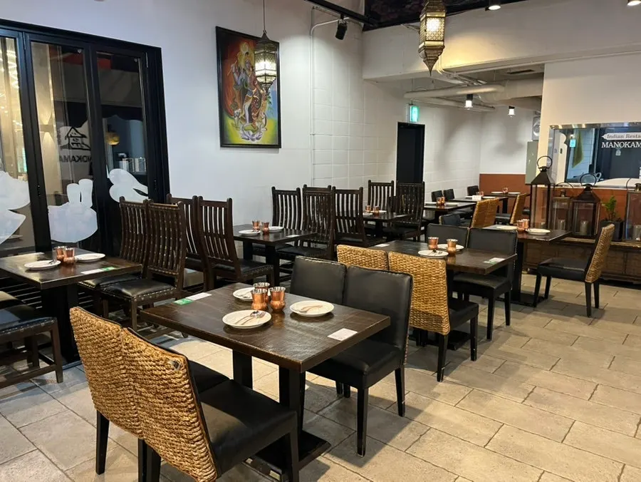 Interior seating at Manokamana with generously spaced tables
