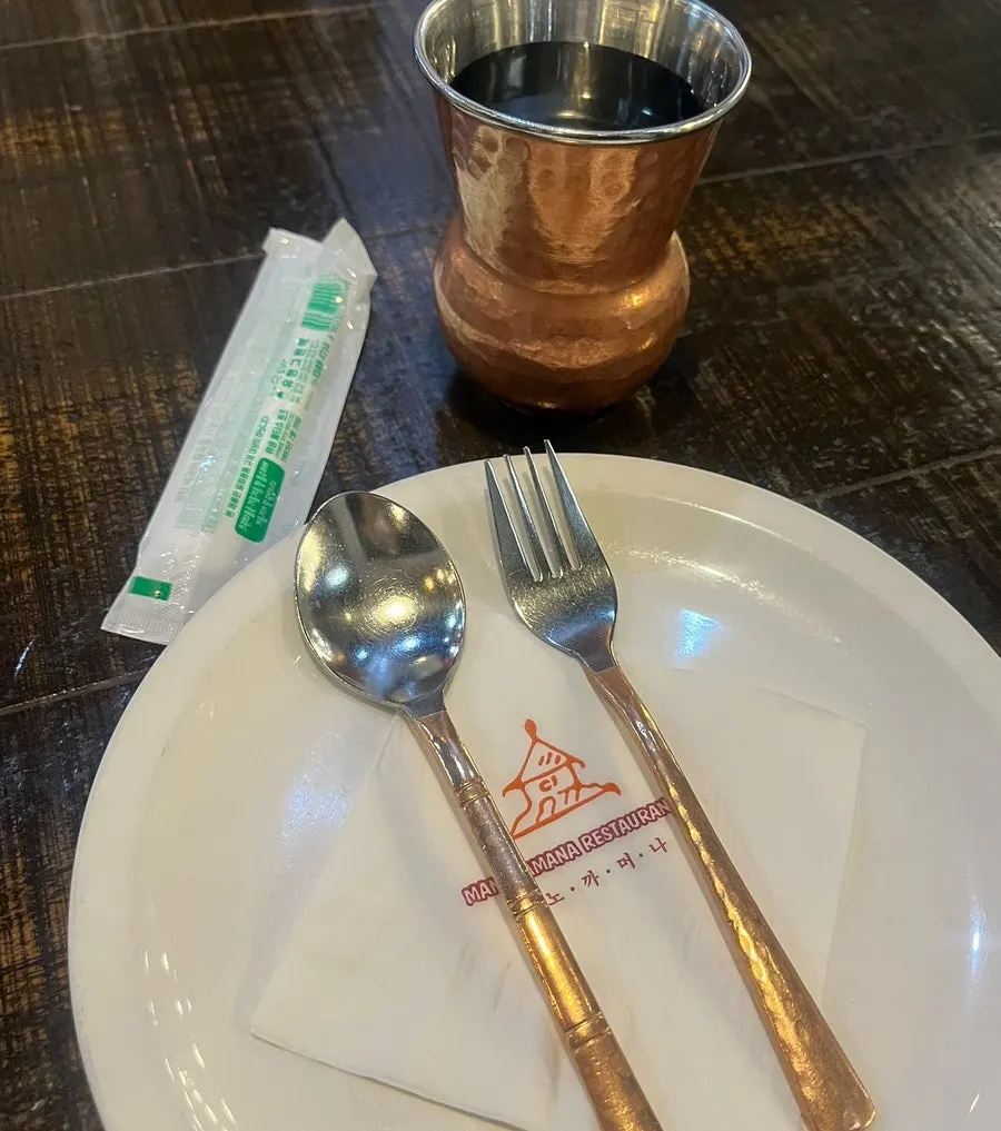 Two curries and sides laid out for a two-person order