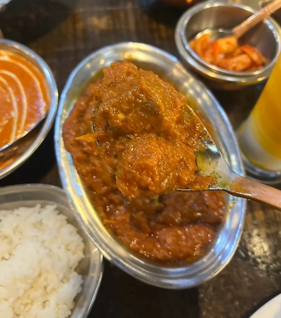 Close-up of mutton do piaja with onions