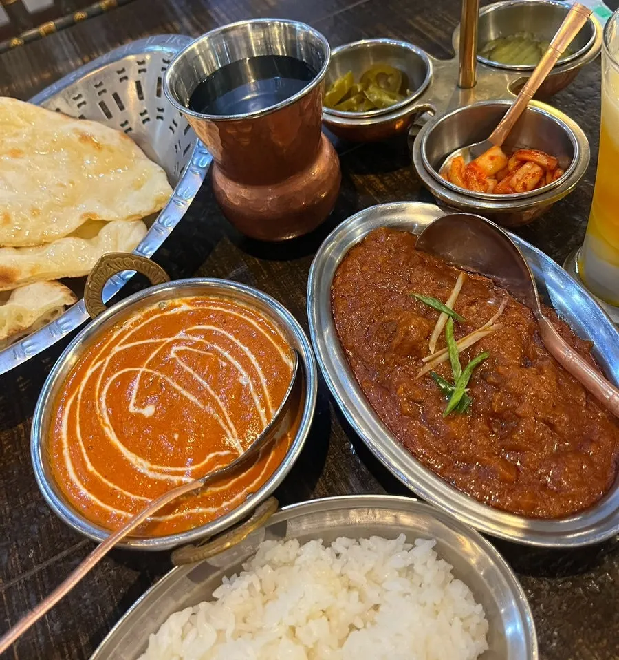 Dipping naan into the curry