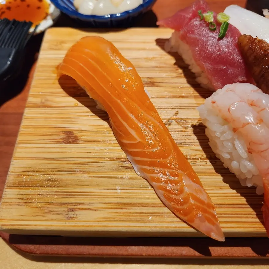 Brushing soy sauce onto sushi