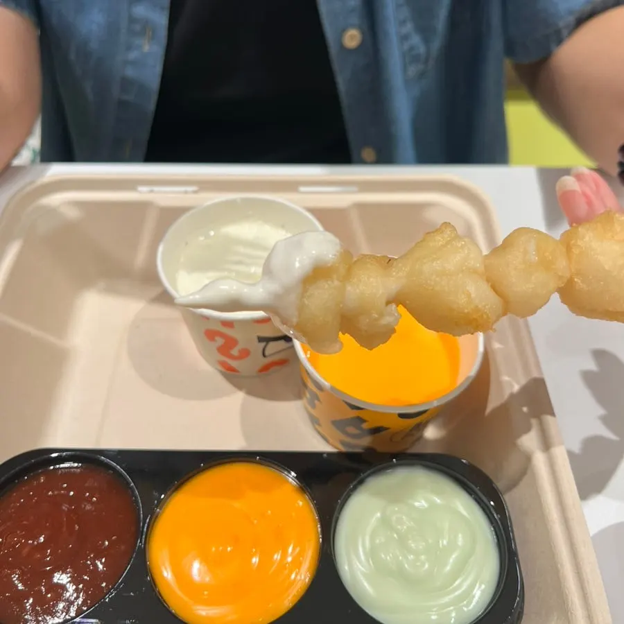 Mini shrimp burger dipped in ranch sauce