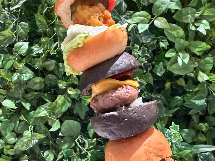 Three mini burgers on a skewer