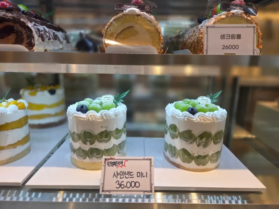Cakes and sandwiches in a refrigerated display