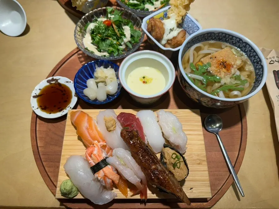 Sushi chefs preparing food at the open kitchen counter