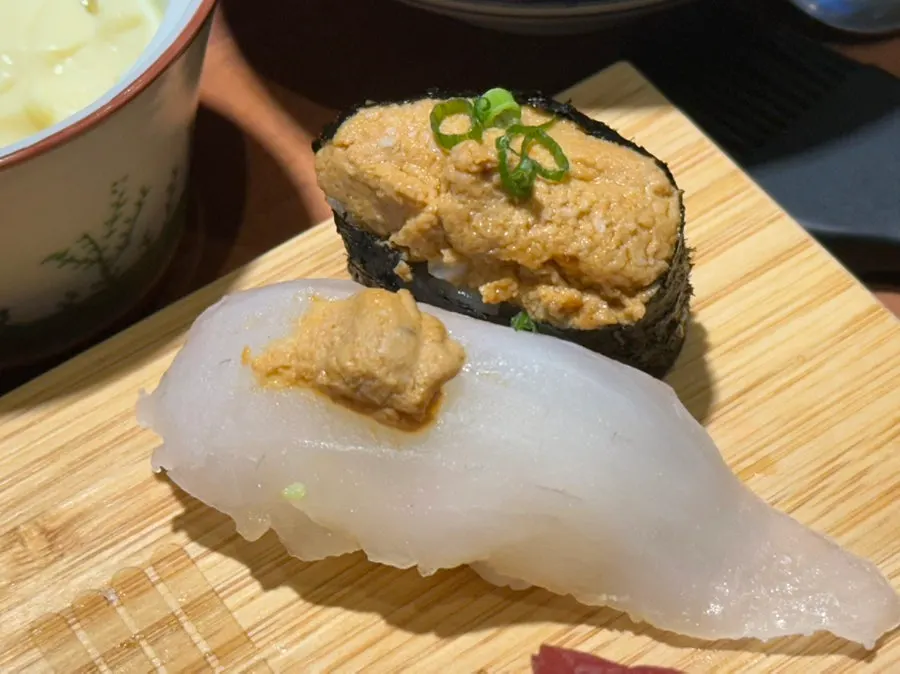 Soy sauce being brushed onto sushi with a dedicated brush